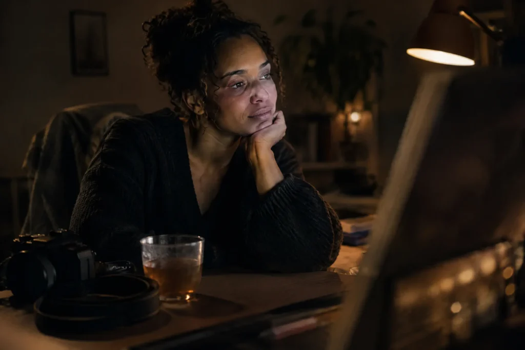 A Christian wedding photographer at her desk long after the wedding, editing the last frames of a gallery
